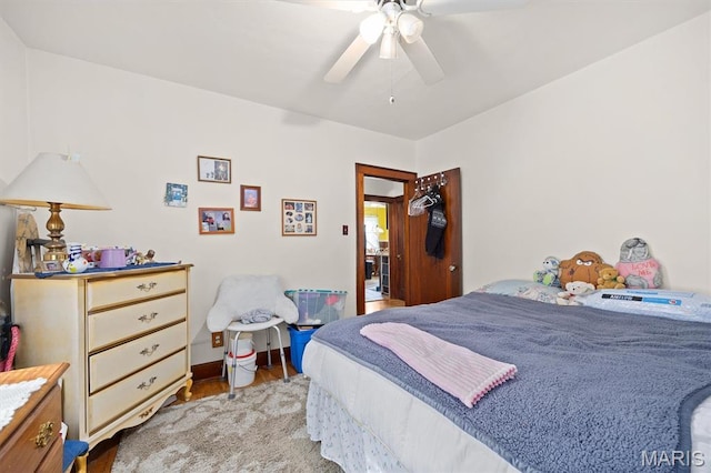 bedroom featuring wood finished floors and a ceiling fan