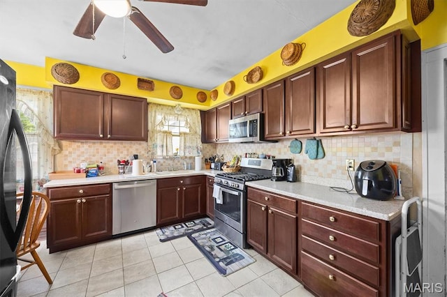 kitchen with stainless steel appliances, light countertops, decorative backsplash, and a ceiling fan