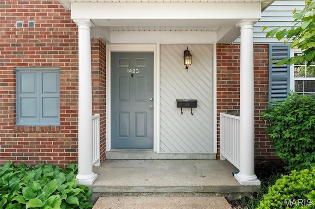 property entrance featuring brick siding