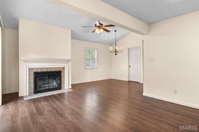 unfurnished living room with a ceiling fan, a chandelier, a tiled fireplace, wood finished floors, and baseboards