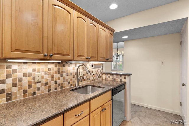 kitchen with dishwasher, a sink, dark stone countertops, baseboards, and decorative backsplash