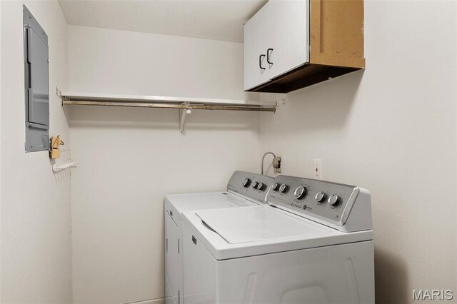 washroom with washing machine and dryer and cabinet space
