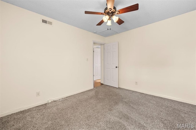 spare room featuring carpet floors, ceiling fan, and baseboards