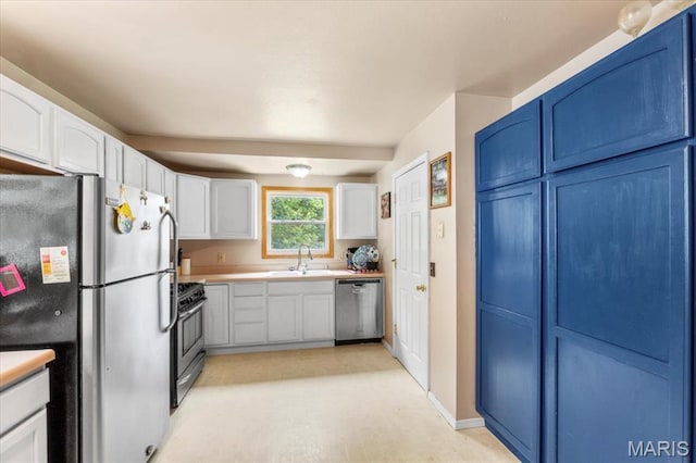 2270 Grants Pkwy, Florissant, MO 63031 - kitchen with stainless steel appliances, a sink, white cabinets, light countertops, and blue cabinets