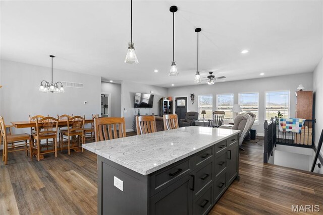25 Gregory Michael Ln, Wright City, MO 63390 - kitchen with dark wood-style floors, a ceiling fan, open floor plan, a kitchen island, and decorative light fixtures