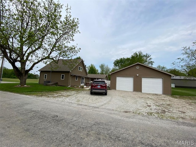 view of front facade with a detached garage and an outdoor structure