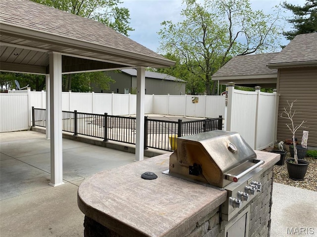 view of patio with a fenced backyard, a grill, and area for grilling