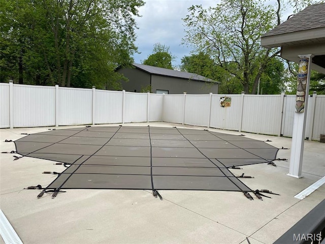 view of swimming pool with a fenced backyard and a patio area