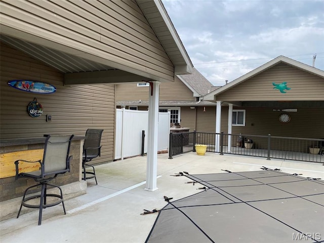 view of patio / terrace featuring fence and a covered pool