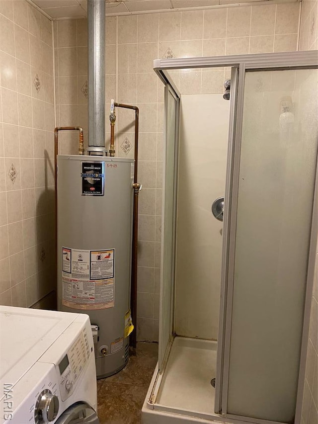 utility room featuring water heater and washer / clothes dryer