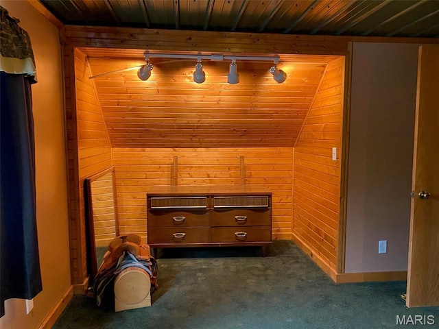 bonus room featuring wood walls, dark carpet, wooden ceiling, and baseboards