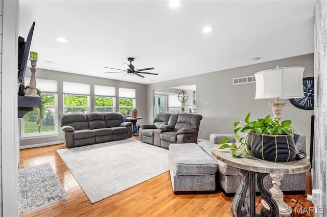 living room with a ceiling fan, light wood-style flooring, and recessed lighting