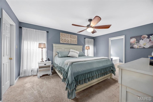 bedroom with light colored carpet and a ceiling fan