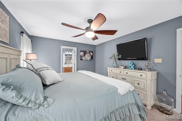 bedroom featuring light colored carpet, a ceiling fan, and ensuite bathroom