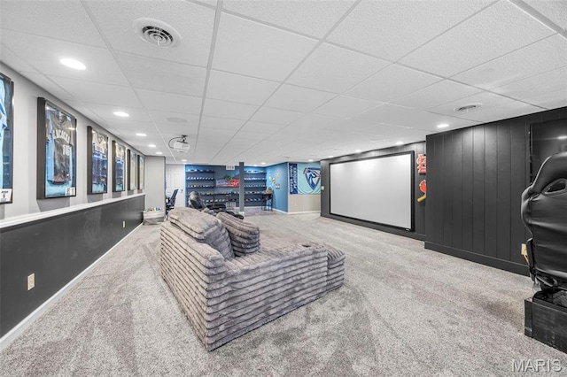 carpeted cinema with a drop ceiling, baseboards, bar, and recessed lighting