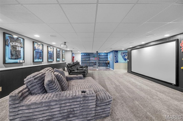 carpeted home theater room featuring a paneled ceiling, bar area, recessed lighting, and baseboards