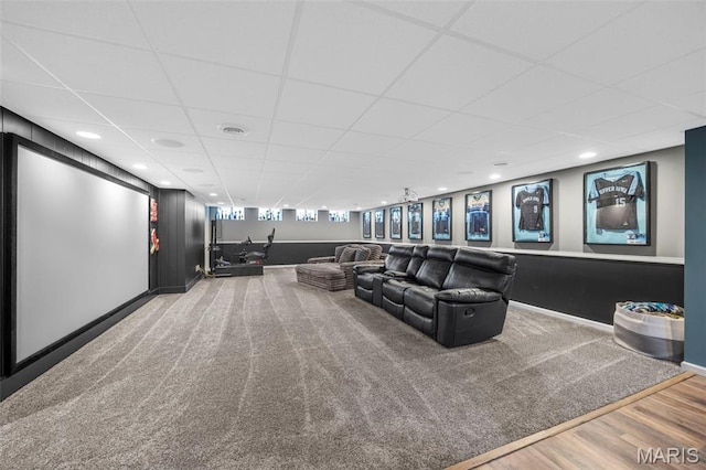 cinema featuring a drop ceiling, wood finished floors, and recessed lighting