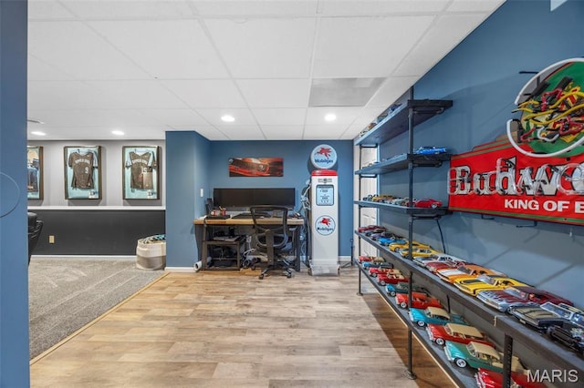 home office with wood finished floors, recessed lighting, baseboards, and a paneled ceiling