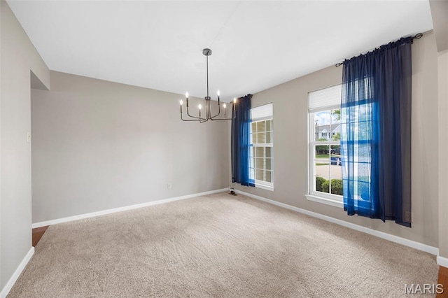 12 Lambeth Ln Unit 11B, Dardenne Prairie, MO 63368 - empty room featuring a chandelier, baseboards, and carpet flooring