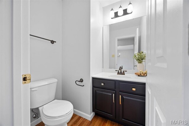 12 Lambeth Ln Unit 11B, Dardenne Prairie, MO 63368 - half bath featuring toilet, wood finished floors, vanity, and baseboards