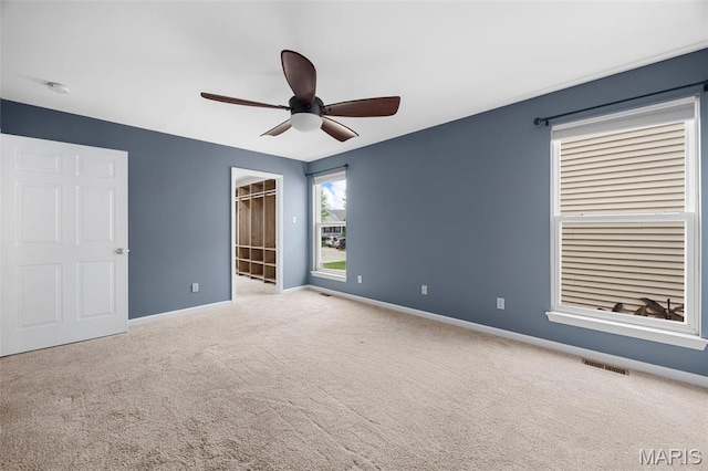 12 Lambeth Ln Unit 11B, Dardenne Prairie, MO 63368 - unfurnished bedroom with carpet floors, baseboards, a walk in closet, and ceiling fan
