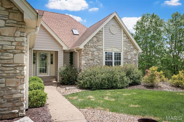 1189 Turnberry Dr, Innsbrook, MO 63390 - view of front of home with stone siding, roof with shingles, and a front lawn