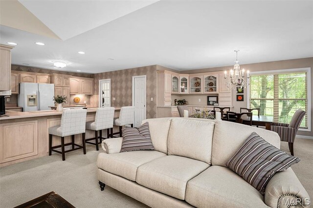 1189 Turnberry Dr, Innsbrook, MO 63390 - living area featuring light carpet, a chandelier, recessed lighting, lofted ceiling, and wallpapered walls