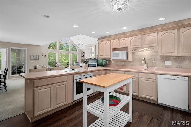 1189 Turnberry Dr, Innsbrook, MO 63390 - kitchen featuring white appliances, a sink, a peninsula, a chandelier, and light countertops