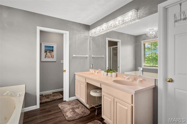 1189 Turnberry Dr, Innsbrook, MO 63390 - bathroom with wood finished floors, a jetted tub, double vanity, baseboards, and a shower stall