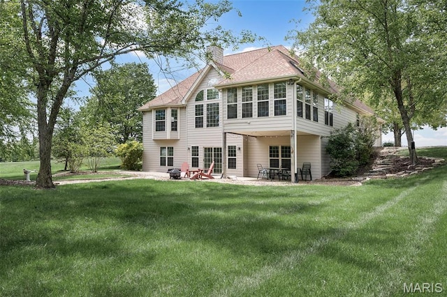 1189 Turnberry Dr, Innsbrook, MO 63390 - rear view of house featuring a chimney, a patio area, a lawn, and roof with shingles