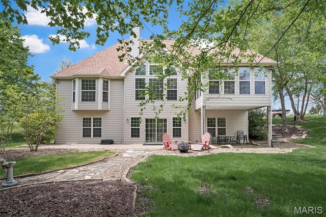 1189 Turnberry Dr, Innsbrook, MO 63390 - back of house with a patio area, a yard, a chimney, and a fire pit