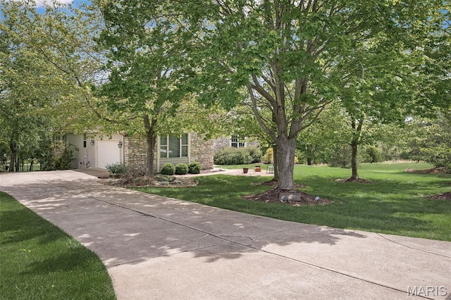 1189 Turnberry Dr, Innsbrook, MO 63390 - obstructed view of property featuring stone siding, concrete driveway, a garage, and a front yard