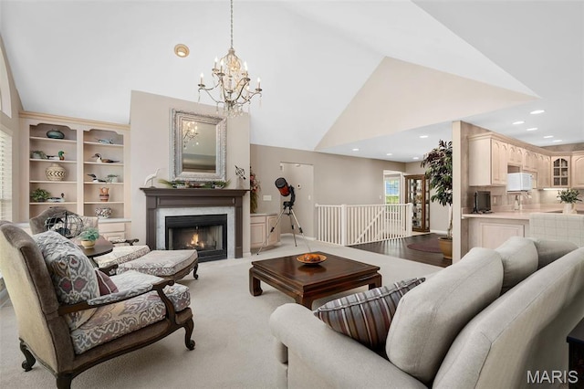 1189 Turnberry Dr, Innsbrook, MO 63390 - living area featuring high vaulted ceiling, a chandelier, a lit fireplace, light carpet, and recessed lighting