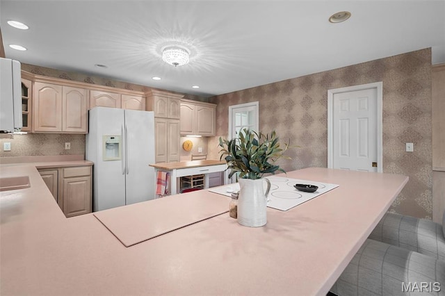 1189 Turnberry Dr, Innsbrook, MO 63390 - kitchen with white appliances, light countertops, wallpapered walls, a sink, and recessed lighting