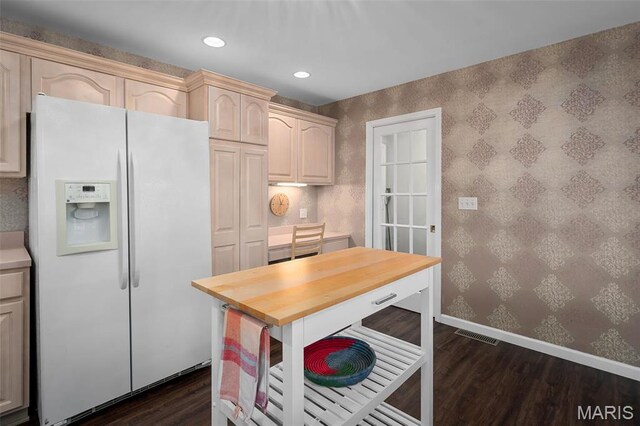1189 Turnberry Dr, Innsbrook, MO 63390 - kitchen featuring white fridge with ice dispenser, wallpapered walls, dark wood-type flooring, baseboards, and wood counters