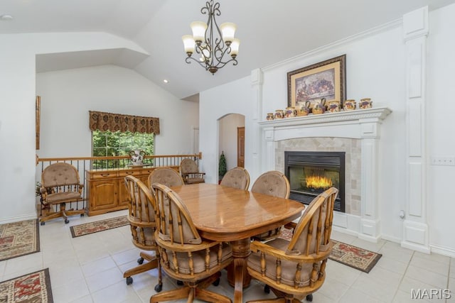 24473 Remington, Lebanon, MO 65536 - dining space with lofted ceiling, light tile patterned flooring, a tiled fireplace, a chandelier, and arched walkways
