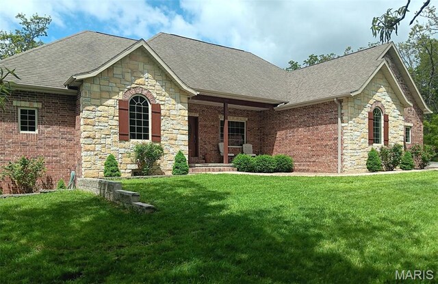 24473 Remington, Lebanon, MO 65536 - view of front of home with a shingled roof, stone siding, and a front lawn
