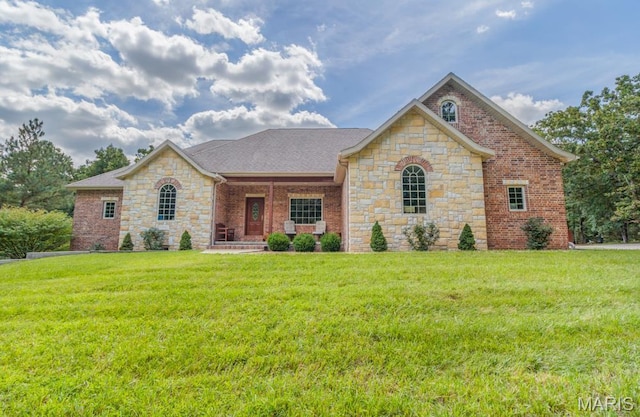 24473 Remington, Lebanon, MO 65536 - view of front of house with stone siding, a porch, a front lawn, and brick siding