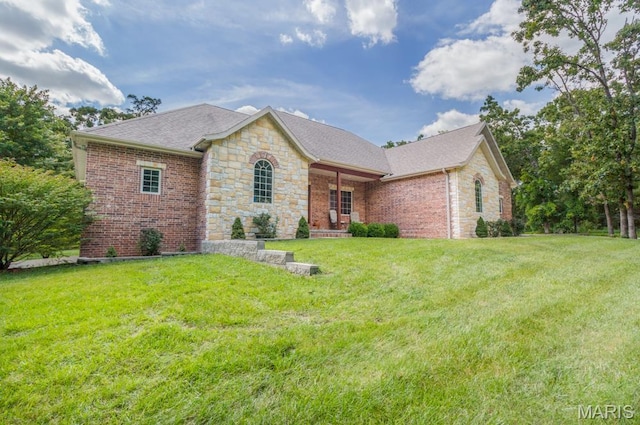 24473 Remington, Lebanon, MO 65536 - view of front facade featuring stone siding, a front lawn, a shingled roof, and brick siding