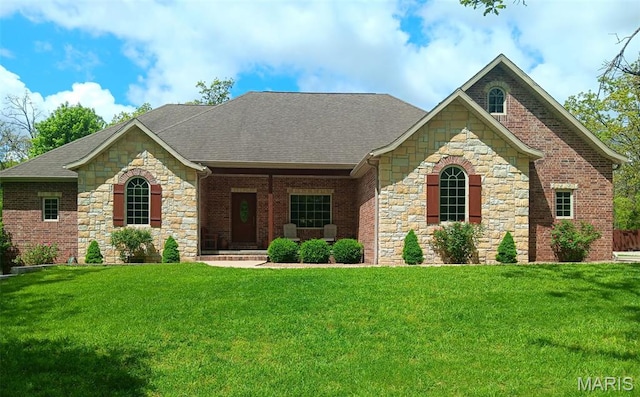 24473 Remington, Lebanon, MO 65536 - view of front of home featuring stone siding, roof with shingles, and a front lawn