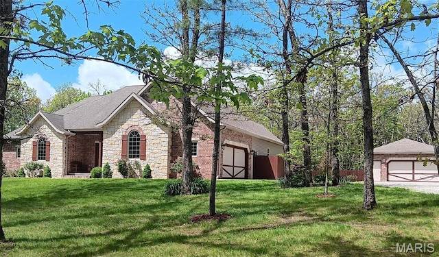 24473 Remington, Lebanon, MO 65536 - view of home's exterior featuring stone siding, a lawn, an outbuilding, a garage, and roof with shingles