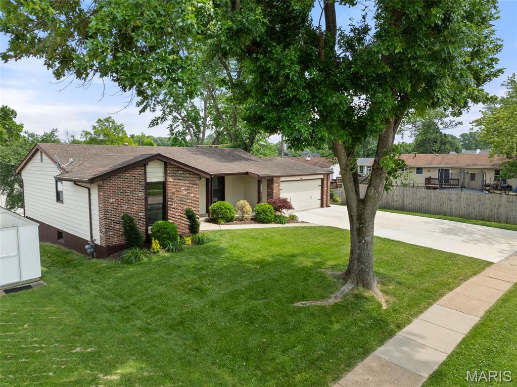 2224 Ben Clare Dr, Fenton, MO 63026 - view of front of home with driveway, brick siding, and an attached garage