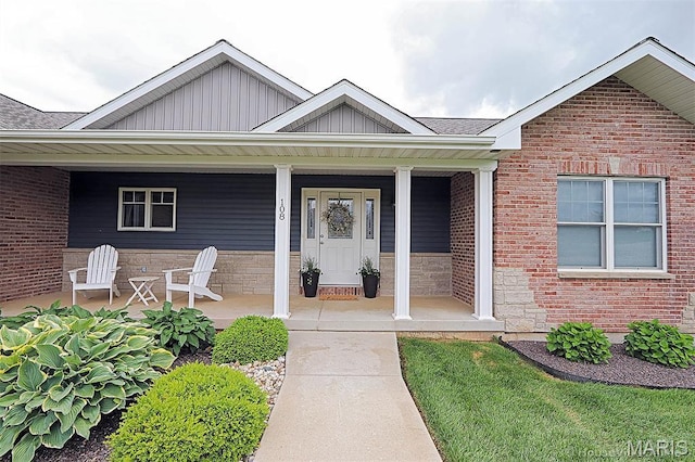 108 Buford Mountain Rd, Farmington, MO 63640 - doorway to property featuring board and batten siding, brick siding, and a porch