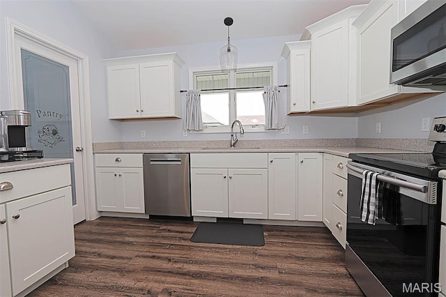 108 Buford Mountain Rd, Farmington, MO 63640 - kitchen with appliances with stainless steel finishes, a sink, dark wood-style floors, white cabinetry, and light countertops