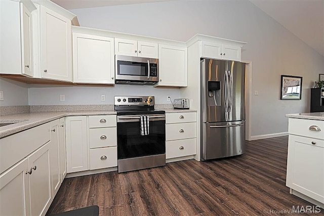 108 Buford Mountain Rd, Farmington, MO 63640 - kitchen with appliances with stainless steel finishes, lofted ceiling, dark wood-type flooring, light countertops, and white cabinets