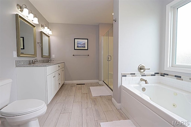 108 Buford Mountain Rd, Farmington, MO 63640 - bathroom featuring toilet, a whirlpool tub, double vanity, a shower stall, and wood finish floors