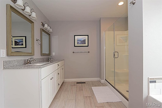 108 Buford Mountain Rd, Farmington, MO 63640 - bathroom with a shower stall, double vanity, baseboards, wood finish floors, and a bathtub