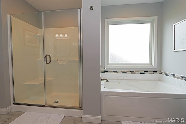 108 Buford Mountain Rd, Farmington, MO 63640 - bathroom featuring a shower stall, a bath, tile patterned flooring, and baseboards