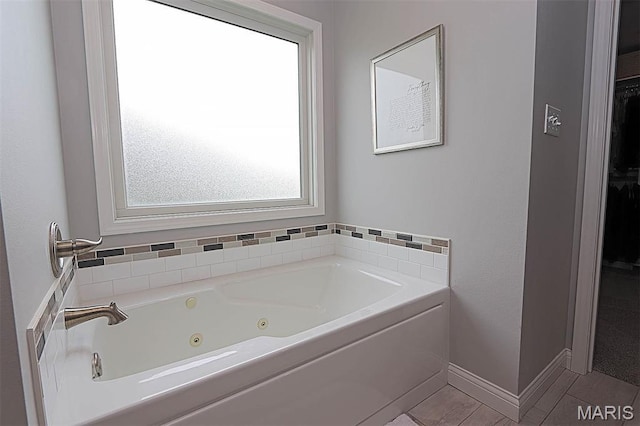 108 Buford Mountain Rd, Farmington, MO 63640 - full bathroom with a whirlpool tub, a spacious closet, tile patterned floors, and baseboards