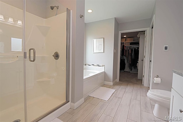 108 Buford Mountain Rd, Farmington, MO 63640 - bathroom with a stall shower, a garden tub, toilet, a spacious closet, and baseboards